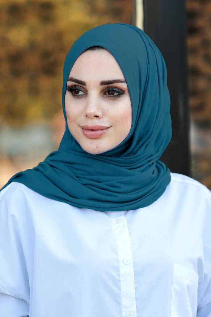 Our soft, stretchy Premium Jersey Hijabs are effortless to style and outrageously comfortable to wear. The perfect go-to hijab! Super-soft, effortless, and durable enough to last. It's breathable, fully opaque, and Jersey works well in all climates, can be worn without an underscarf or pins, and makes a great option for working out. Comes in a selection of colors ideal to finish off any look.