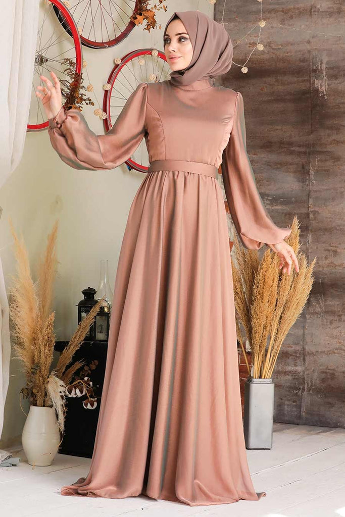 The ultra-elegant Nour dress is perfect for special occasions. This plain party dress will make you stand out on any occasion with its subtle shine fabric and long puff sleeves with buttoned cuffs. Whereas the skirt is flared and floaty which gives a pure elegance look. The gown fastens at the back with a single button and concealed zip and is fully lined.