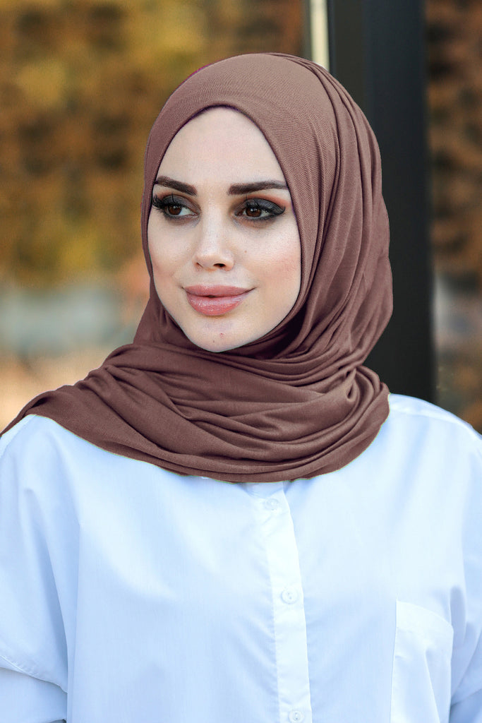 Our soft, stretchy Premium Jersey Hijabs are effortless to style and outrageously comfortable to wear, with a subtle sheen that adds polish to your look. The perfect go-to hijab! Super-soft, effortless, and durable enough to last. It's breathable, fully opaque, and Jersey works well in all climates, can be worn without an underscarf or pins, and makes a great option for working out. Comes in a selection of colors ideal to finish off any look.